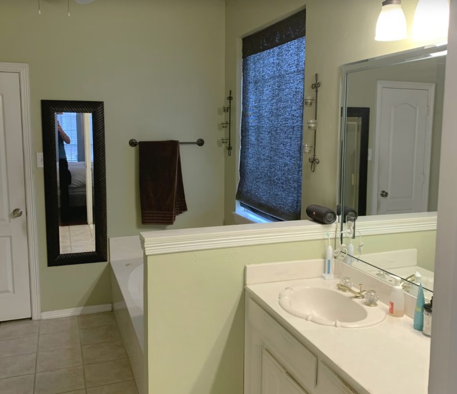 Bathroom before renovation — pale green walls, dated vanity